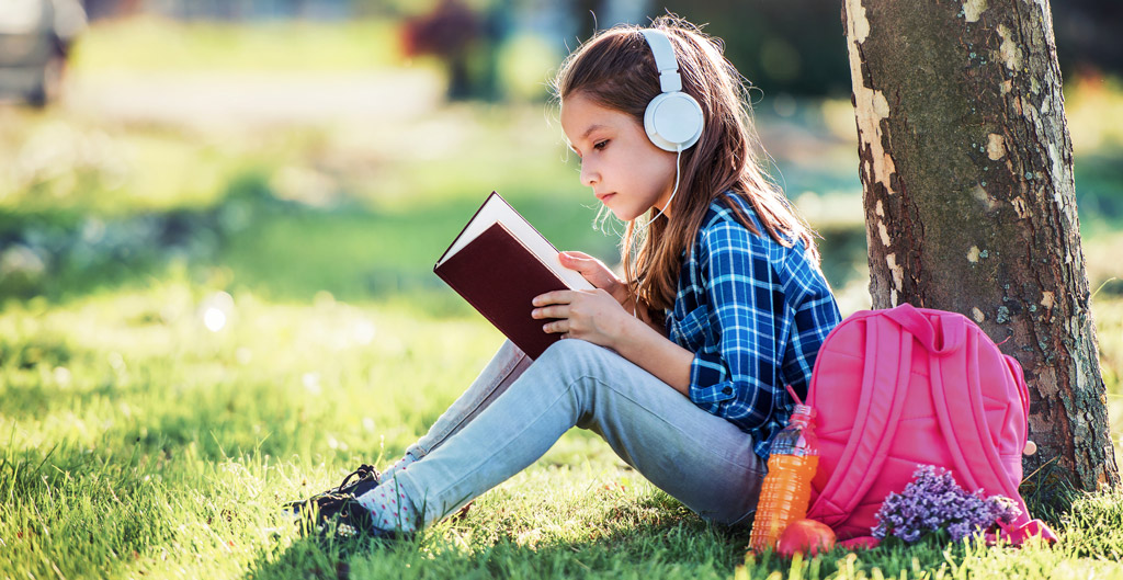 Kid studying while listening to music